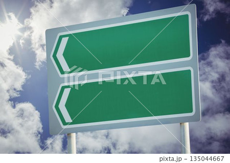 Green sign post against cloudy sky 135044667