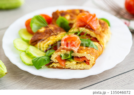 Omelet with salmon and green leaves for a healthy breakfast Omelet with salmon and green leaves for a healthy breakfast 135046072
