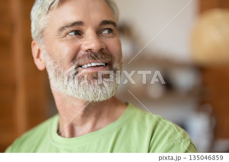 Gray-haired adult man with beard smiling warmly Gray-haired adult man with beard smiling warmly 135046859