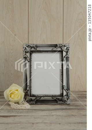 Photo frame and flower on table 135047218
