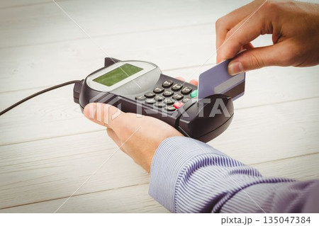 Man paying with credit card Man paying with credit card 135047384