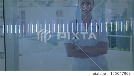 Standing worker in scrubs and monitoring digital waveform in hospital lobby wristwatch, copy space 135047968