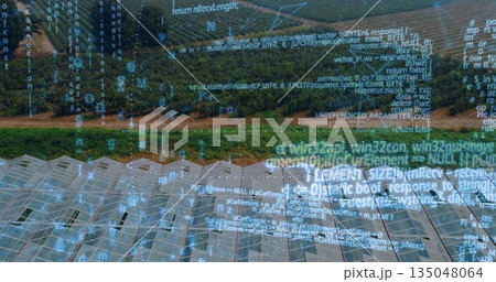 Displaying glass-roofed greenhouses and crop rows spreading across rural farm, with code overlay Displaying glass-roofed greenhouses and crop rows spreading across rural farm, with code overlay 135048064