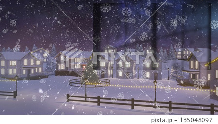 Showing winter village scene glowing through frosted window at night, with decorated evergreen tree 135048097