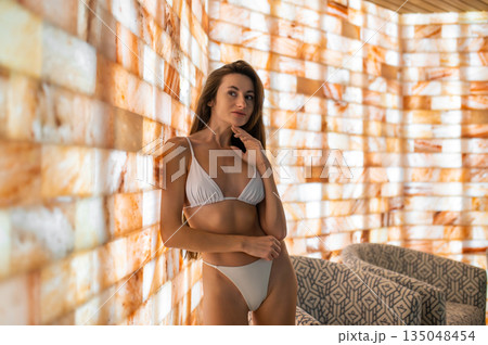 Pretty young caucasian woman having a day in spa salon 135048454