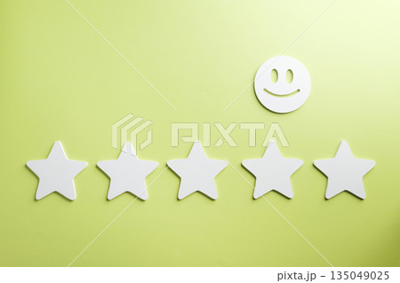 Five star customer feedback review shows excellent satisfaction rating for business service, online survey represents positive experience with cheerful smiley face on a vibrant green background 135049025
