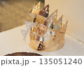 Golden crowns and French galette des rois in a bakery window on the French feast of Saint Epiphany 135051240
