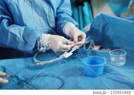 Elimination of blood clots. Vascular endovascular surgery. Surgical interventions on blood vessels. The hand surgeon. Concept of health care. Elimination of blood clots. Vascular endovascular surgery. Surgical interventions on blood vessels. The hand surgeon. Concept of health care. 135051988