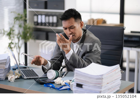 Stressed businessman facing unemployment and business failure in office. 135052104