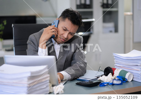 Stressed businessman facing unemployment and business failure in office. Stressed businessman facing unemployment and business failure in office. 135052109
