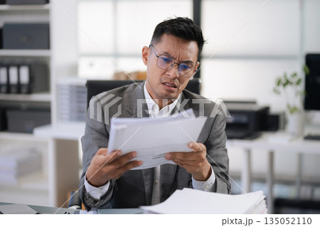 Stressed businessman facing unemployment and business failure in office. 135052110