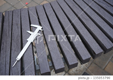 Caliper metal tool on wooden bench background Caliper metal tool on wooden bench background 135053790