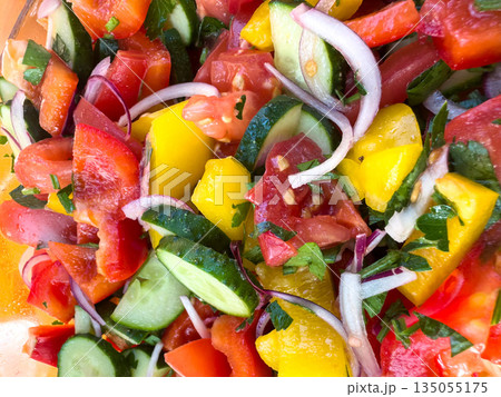 Fresh vegetable salad with tomatoes, cucumbers, and peppers. 135055175