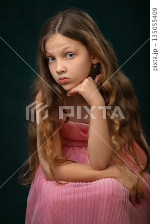 Portrait of a sad girl with long white hair. She is looking at the camera. 135055409