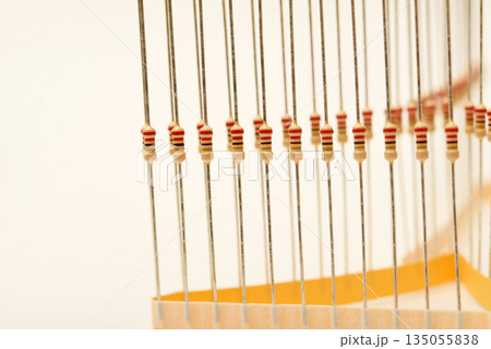 Packaging of film resistors. Resistors with axial terminals.  Yellow resistors in the package. 135055838