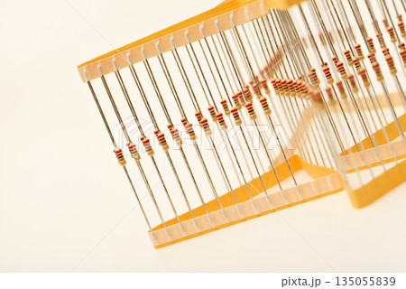 Packaging of film resistors. Resistors with axial terminals.  Yellow resistors in the package. 135055839