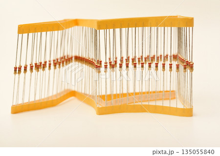 Packaging of film resistors. Resistors with axial terminals.  Yellow resistors in the package. 135055840