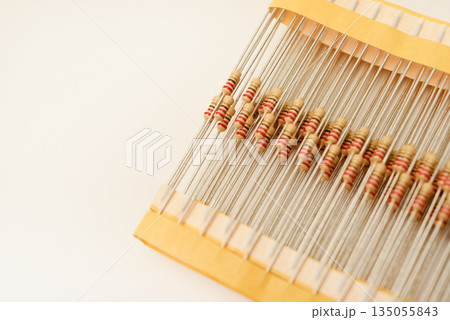 Packaging of film resistors. Resistors with axial terminals. Yellow resistors in the package. Packaging of film resistors. Resistors with axial terminals. Yellow resistors in the package. 135055843