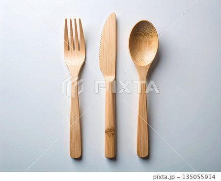 Eco friendly. Set of eco-friendly bamboo cutlery: wooden spoon, fork and knife on a white background. Eco friendly. Set of eco-friendly bamboo cutlery: wooden spoon, fork and knife on a white background. 135055914