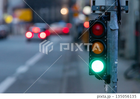 Traffic light shows green signal at intersection during evening rush hour Traffic light shows green signal at intersection during evening rush hour 135056135