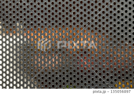 Black Perforated Metal Mesh Texture with Blurred Background. High quality photo 135056897