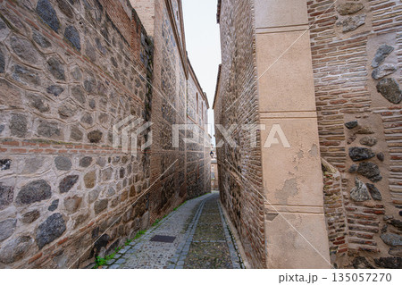 Historic narrow cobblestone street in Toledo Spain during spring 135057270