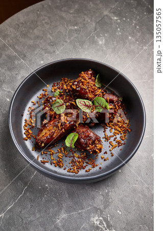 Deliciously Glazed Pork Ribs in Soy Marinade with Fried Rice Toppings Serve in Dark Bowl, Culinary Delight, Savory Meal, Elegant Dining Experience Concept Deliciously Glazed Pork Ribs in Soy Marinade with Fried Rice Toppings Serve in Dark Bowl, Culinary Delight, Savory Meal, Elegant Dining Experience Concept 135057565