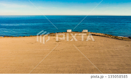 Coast view with two campers camping on sea shore, Spain Coast view with two campers camping on sea shore, Spain 135058585