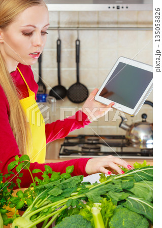 Woman having green vegetables thinking about cooking 135058826