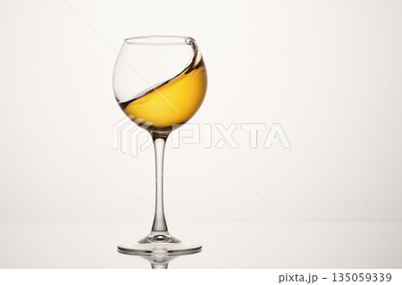White wine diagonal wave, curl is in stemmed glass. White wine diagonal wave, curl is in stemmed glass. 135059339