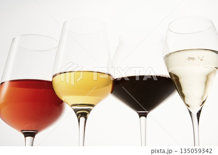 Pink, white, red, sparkling alcoholic drinks in wine glasses. 135059342