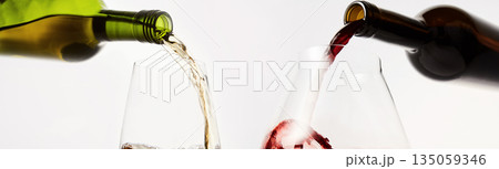 Pair of wineglasses are filled with white, red wine. Pair of wineglasses are filled with white, red wine. 135059346