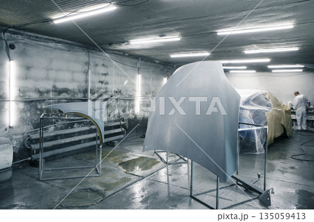 Preparation for painting car parts in the paint chamber. Repair and restoration vehicles after accident. Preparation for painting car parts in the paint chamber. Repair and restoration vehicles after accident. 135059413