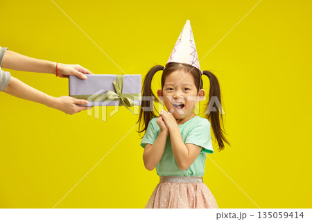 Child's Delight. Receiving Birthday Present with a Big Smile and Wide Open Mouth 135059414