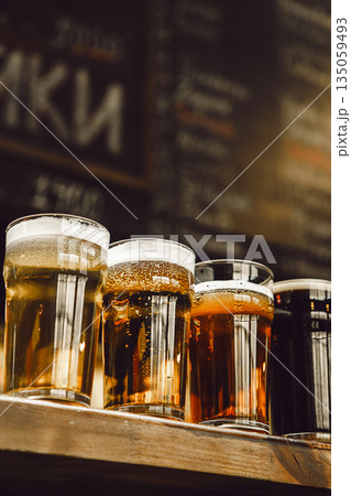 Four Distinct Beers Showcased in Glasses on Bar Counter 135059493