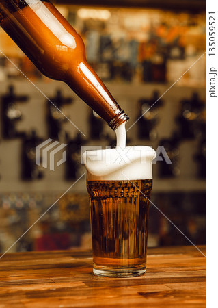 Pouring Cold Beer Into Chilled Glass at Lively Bar Pouring Cold Beer Into Chilled Glass at Lively Bar 135059521