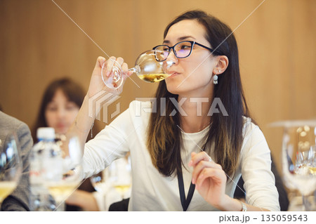 Female Sommelier Tasting White Wine Female Sommelier Tasting White Wine 135059543