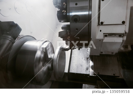 Rotation of aluminium part on CNC metalworking machinery. Working of milling machine with Control Numerical Computer.  135059558