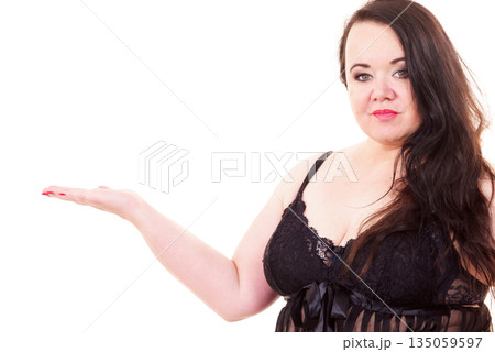 Woman plus size in lingerie holds open hand Woman plus size in lingerie holds open hand 135059597