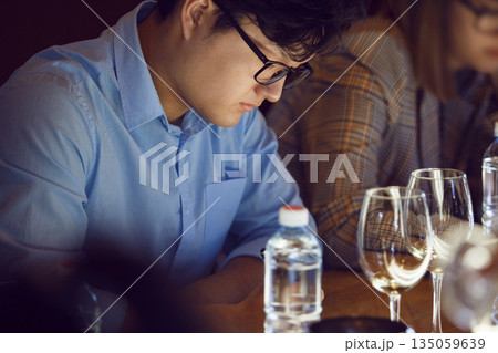 Man Analyzing White Wine Glasses Sitting Table During Passes Training for Sommelier Man Analyzing White Wine Glasses Sitting Table During Passes Training for Sommelier 135059639
