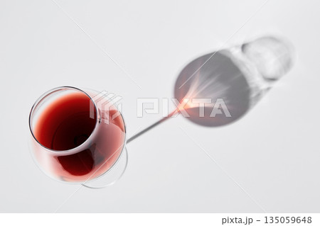 Red wine is in wineglass isolated on white background. Red wine is in wineglass isolated on white background. 135059648