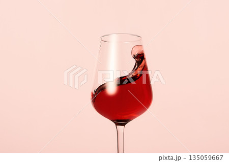 Pink wine beautiful wave, curl, swirl in shiny glass. Pink wine beautiful wave, curl, swirl in shiny glass. 135059667