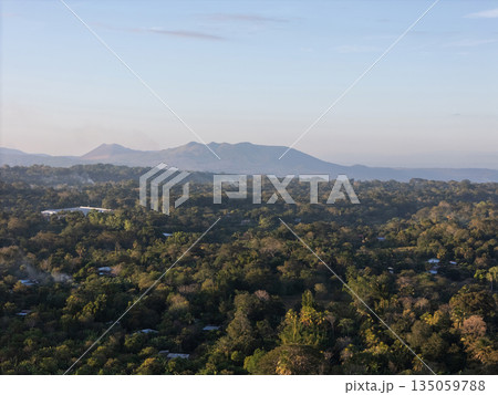 View of green landscape and mountains in the morning light View of green landscape and mountains in the morning light 135059788