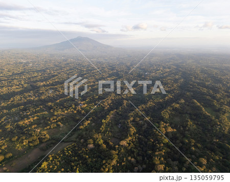 Lush green landscape with mountain view at sunset over hills 135059795