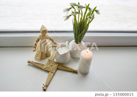 Imbolc altar with brigid doll, cross, snowdrops, candle, milk Imbolc altar with brigid doll, cross, snowdrops, candle, milk 135060015