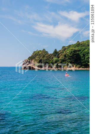 Coastline meets vibrant turquoise sea. Coastal scenery, summer nature, and serene outdoor exploration. Coastline meets vibrant turquoise sea. Coastal scenery, summer nature, and serene outdoor exploration. 135061894