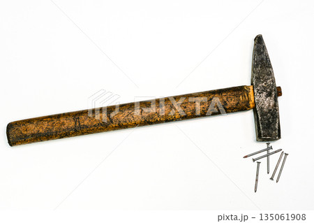 Old carpenter hammer with wooden handle and steel nails on white background, vintage hand tool Old carpenter hammer with wooden handle and steel nails on white background, vintage hand tool 135061908