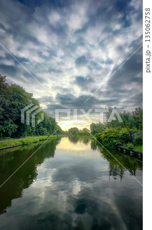 A Beautiful and Serene River Landscape Perfectly Captured Under a Dramatic and Stunning Sky 135062758