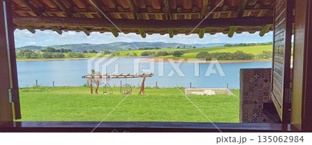 View through a chalet window to the dam and surrounding fields View through a chalet window to the dam and surrounding fields 135062984