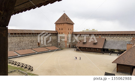 Tower and view of the courtyard of Lida Castle, Belarus. View from the balustrade of the medieval castle's courtyard. Tower and view of the courtyard of Lida Castle, Belarus. View from the balustrade of the medieval castle's courtyard. 135062988